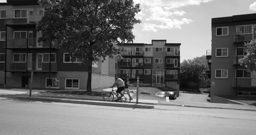 a person riding a bicycle next to a building