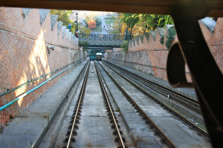 train tracks run along the outside of the wall