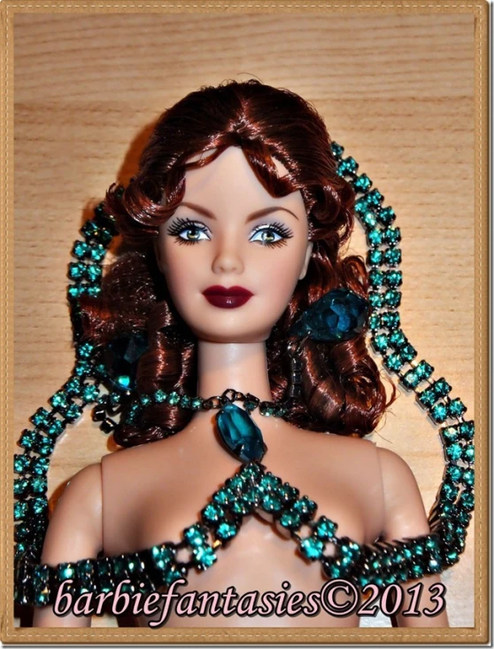 a doll with brown hair and blue beaded collar