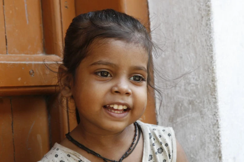 a little girl is smiling for the camera