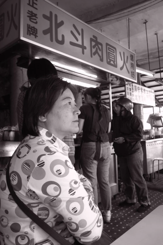 a woman at a food stand waiting to order