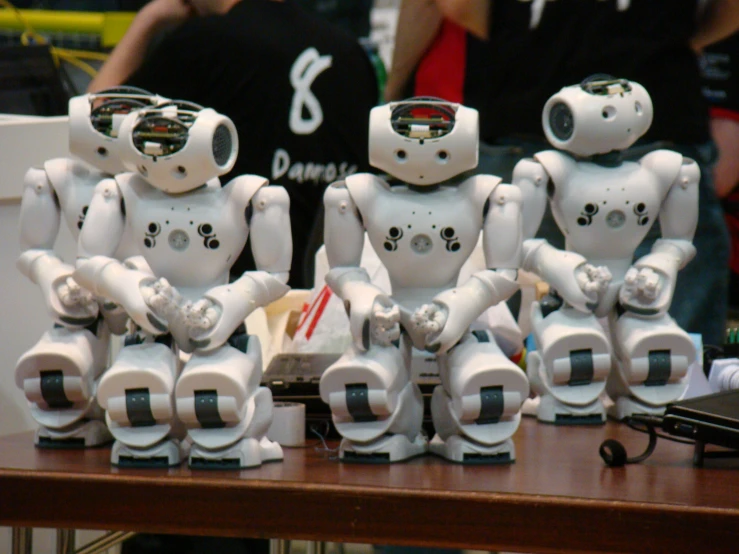 several robots are posed next to each other on the table