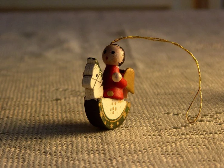 a small figurine is perched on top of the bed