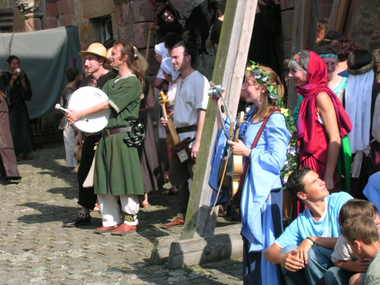 men dressed in roman clothing with various instruments