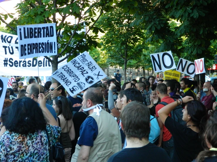 people protesting in a demonstration in front of a large building