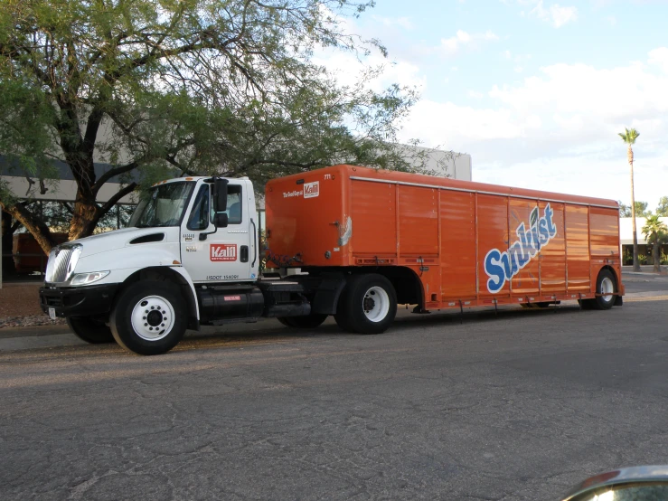 an orange truck is parked on the street