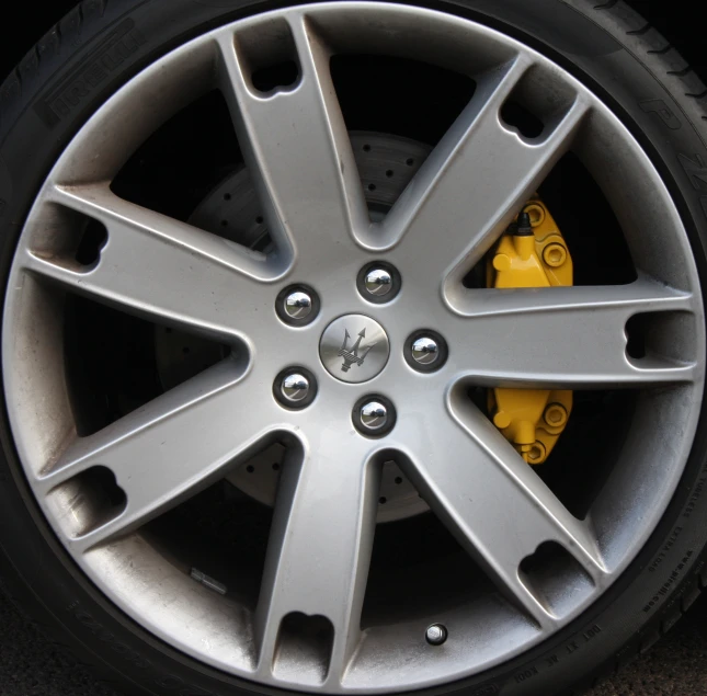 the wheel with yellow ke pads sits on a street