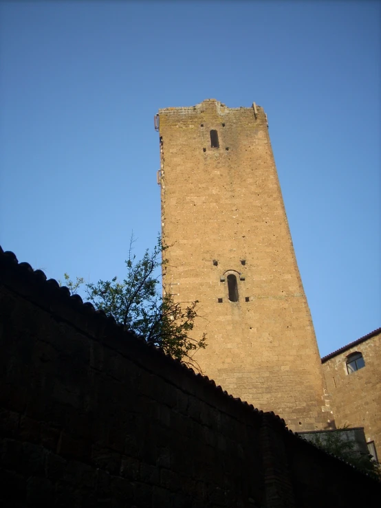 a very tall brick tower with two clocks on it