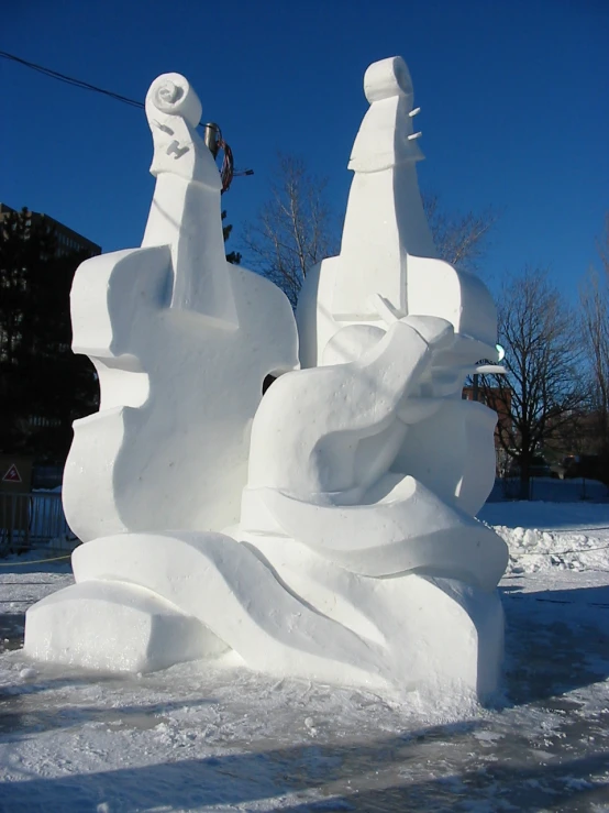 a building made to look like snow with statues of flowers and trees behind it