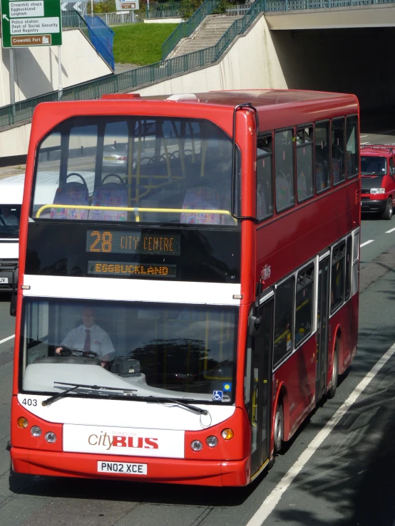 a double decker bus driving down a street