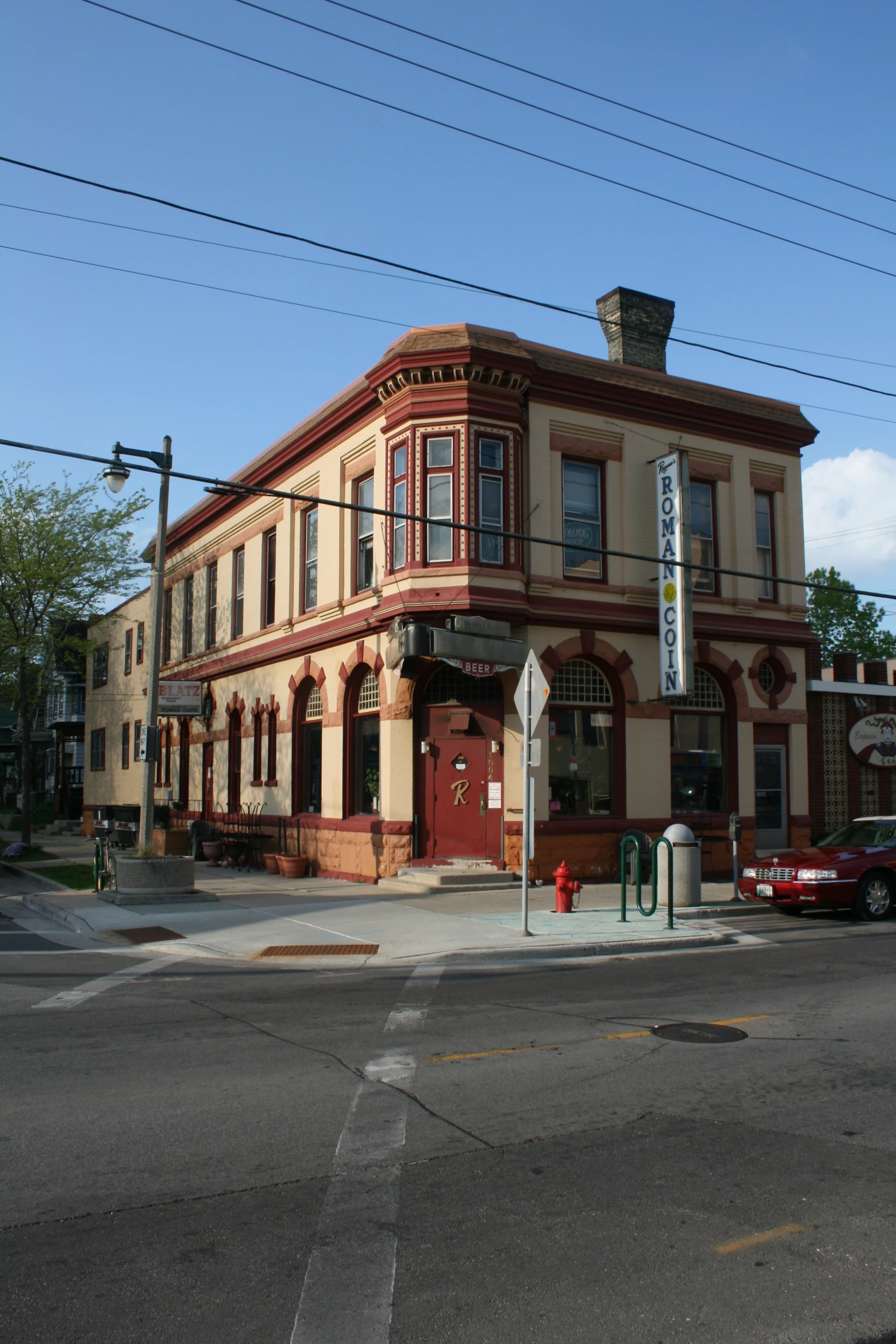 old red brick building with several windows, on an intersection