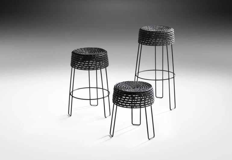 a set of three stools and tables on a plain surface