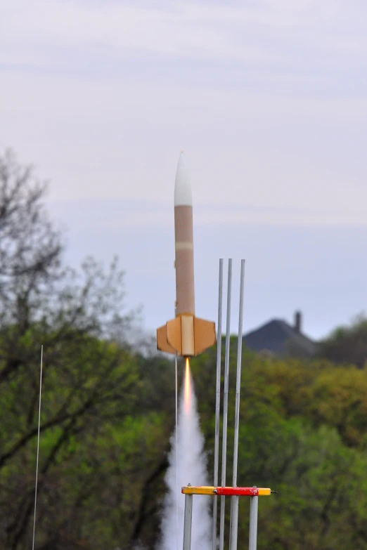 an air - powered rocket takes off into the sky