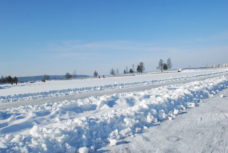 two people are skiing along side some snow