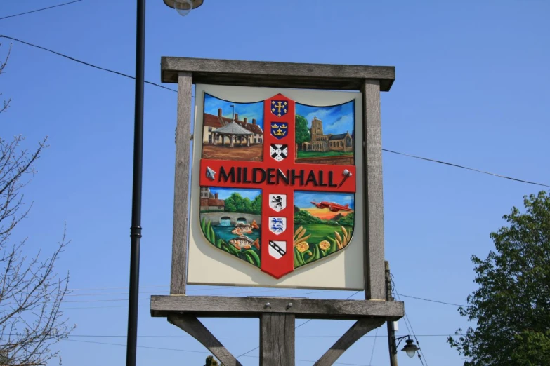 a sign for the town of millenhill against a blue sky