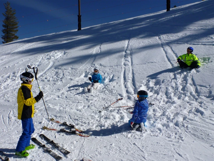 people are riding on skis and snowboards on the snow