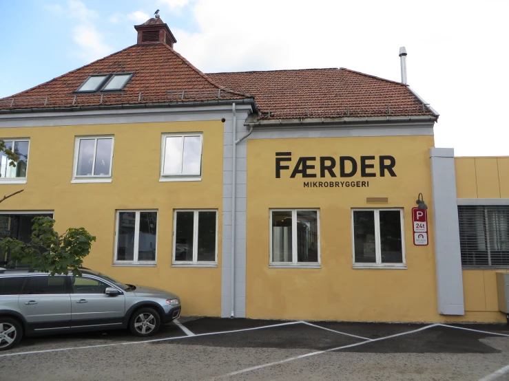 a yellow building with a car in front of it