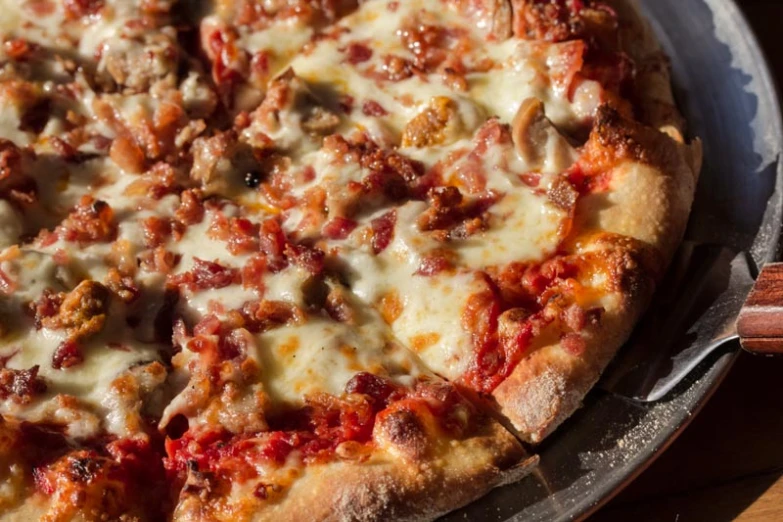 a pizza sitting on top of a wooden table