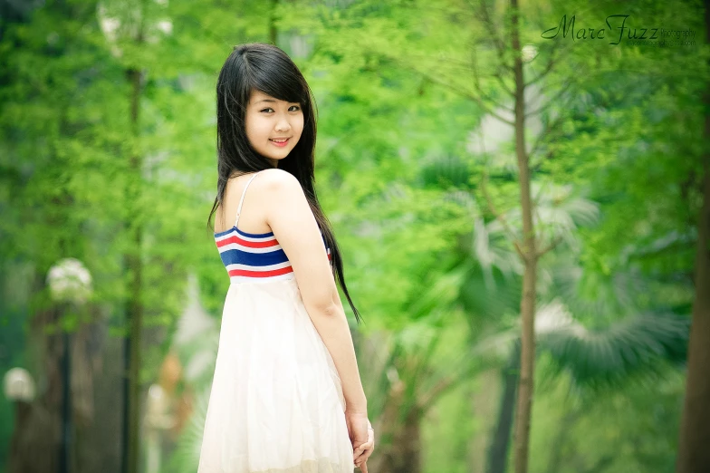 a girl is walking through a wooded area