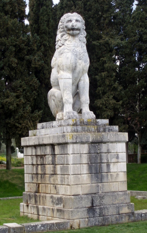 statue of a lion sitting on a stone block