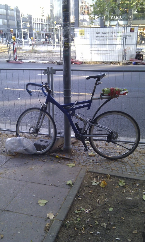 a bike is locked to the side of a pole