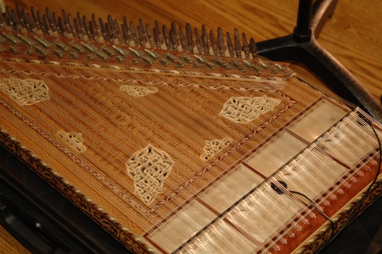 a hand - made wooden object with gold trimming