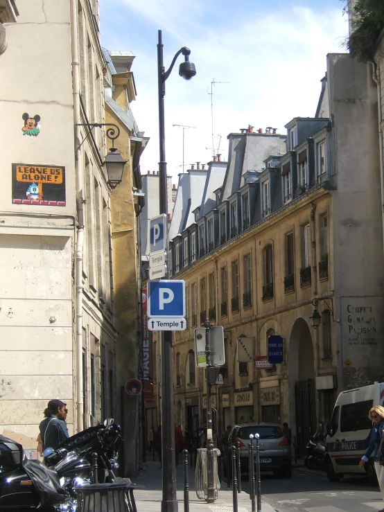 street sign next to bike racks at city intersection