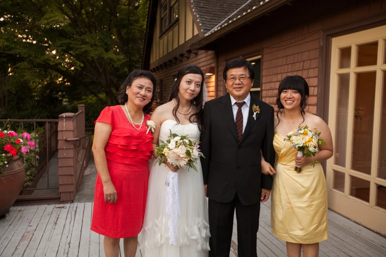 a bride and two groom standing together with other bridesmaids
