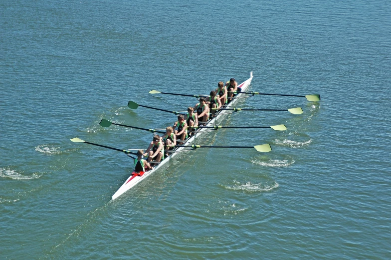 a row boat in the water with some people on it