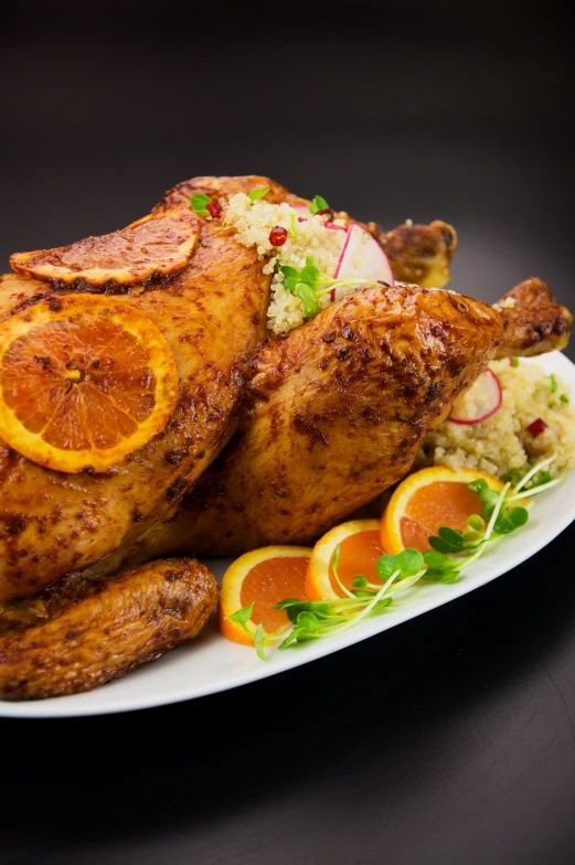 a large roaster turkey is served with fruit and vegetables