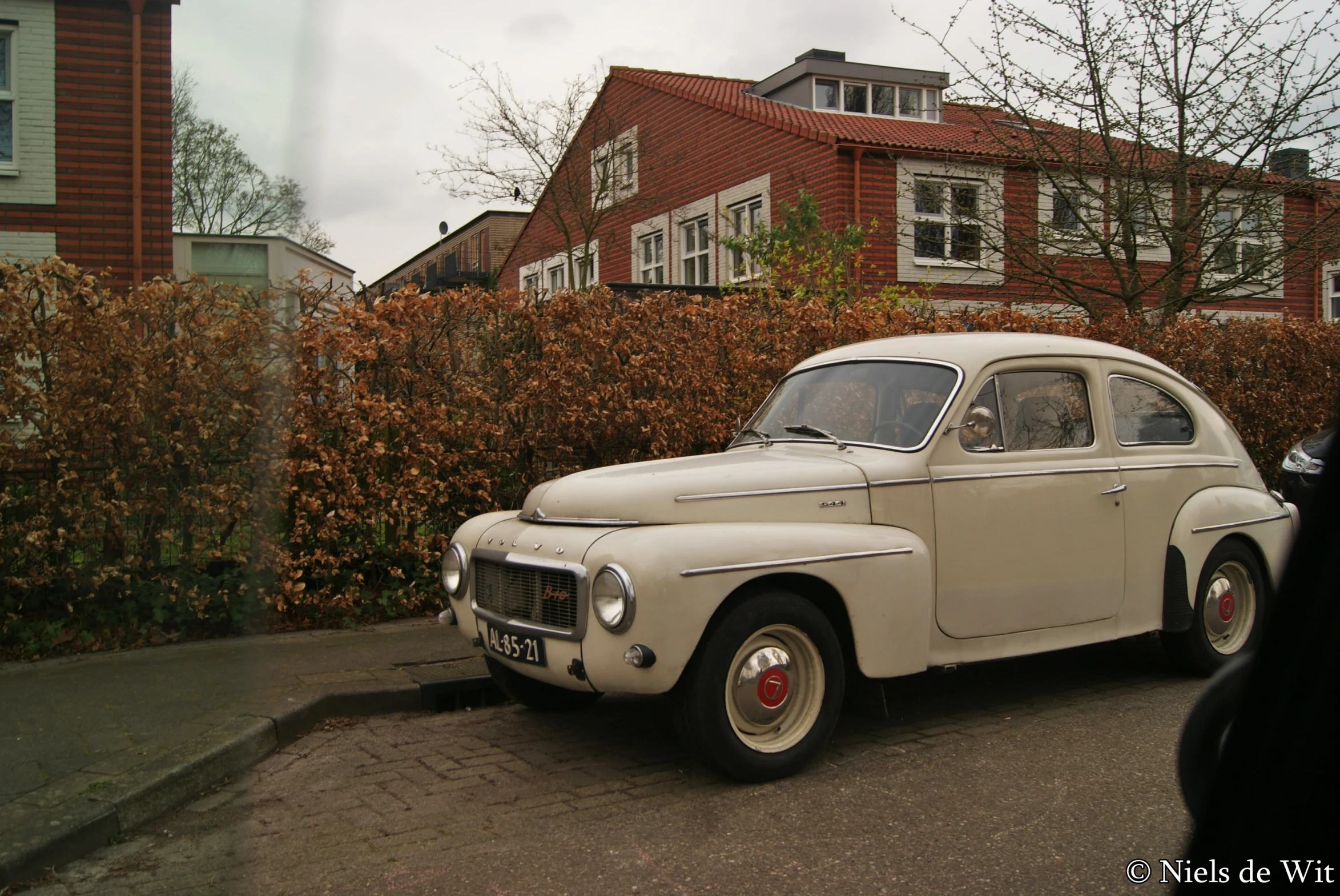 an old car parked on the side of the street