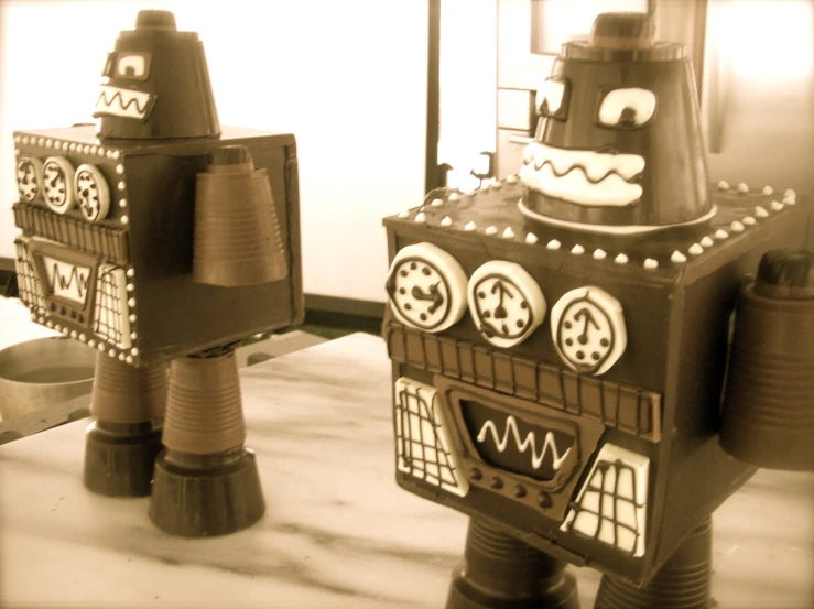 two paper mache robots on display in a museum