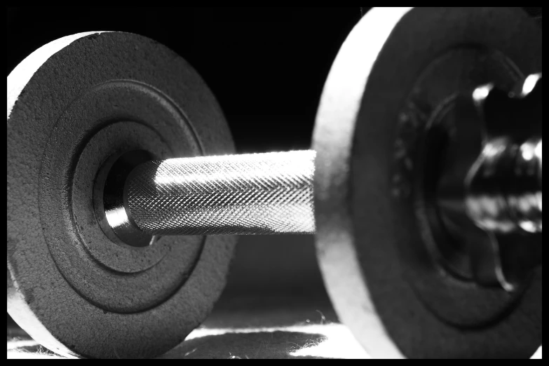 dumbbells with one rubber - coated barbell in black and white
