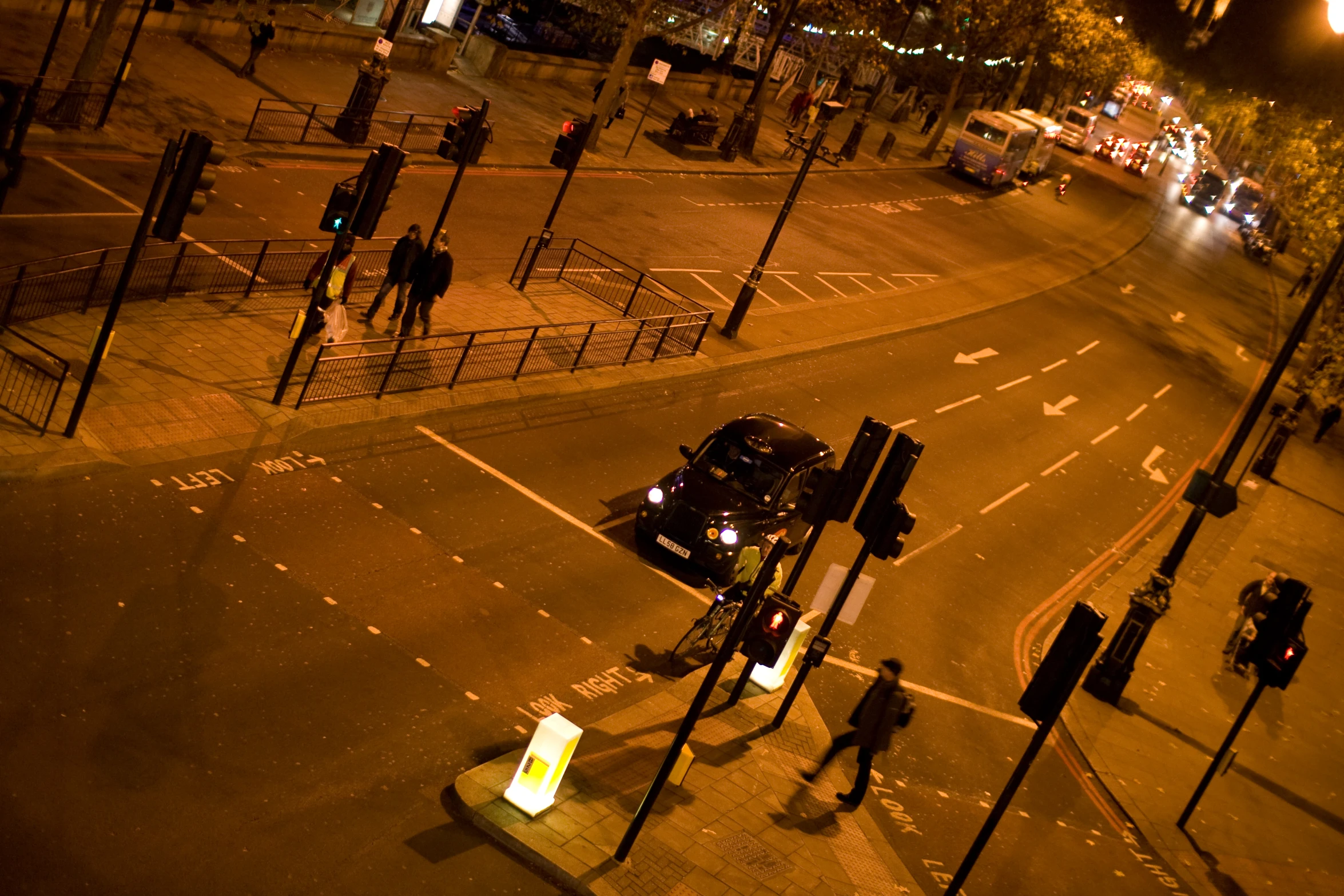 the view from above of an urban intersection with many lights and vehicles