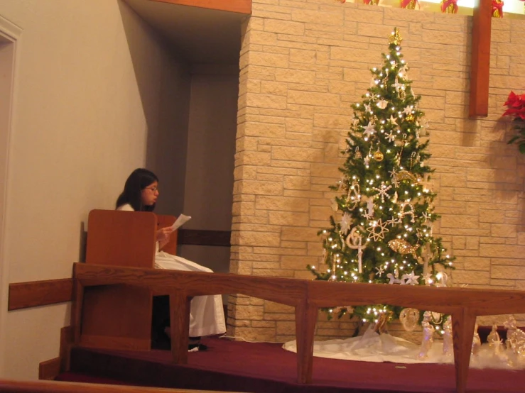 there is a woman sitting in the church reading