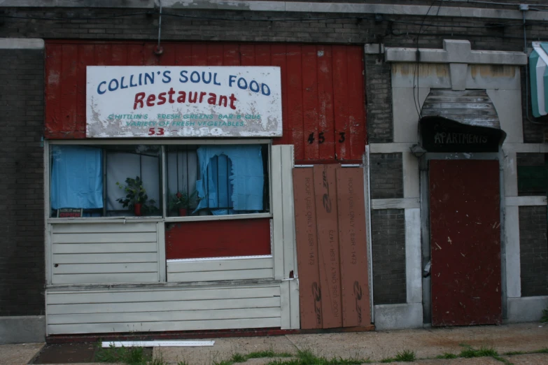 a old restaurant with windows that say colin's soul food