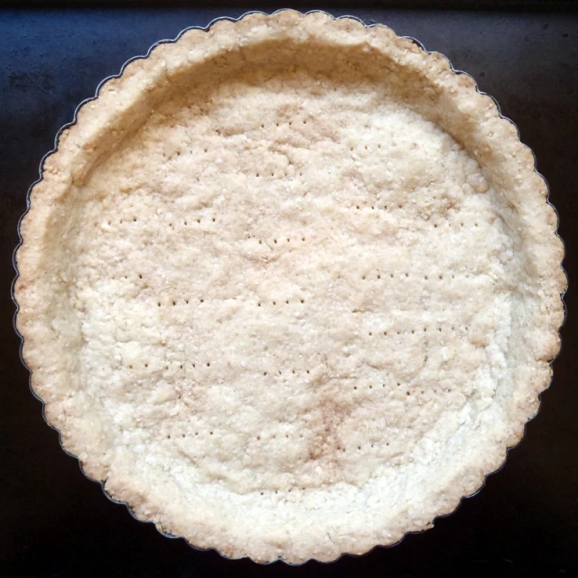 a pie crust on a black surface