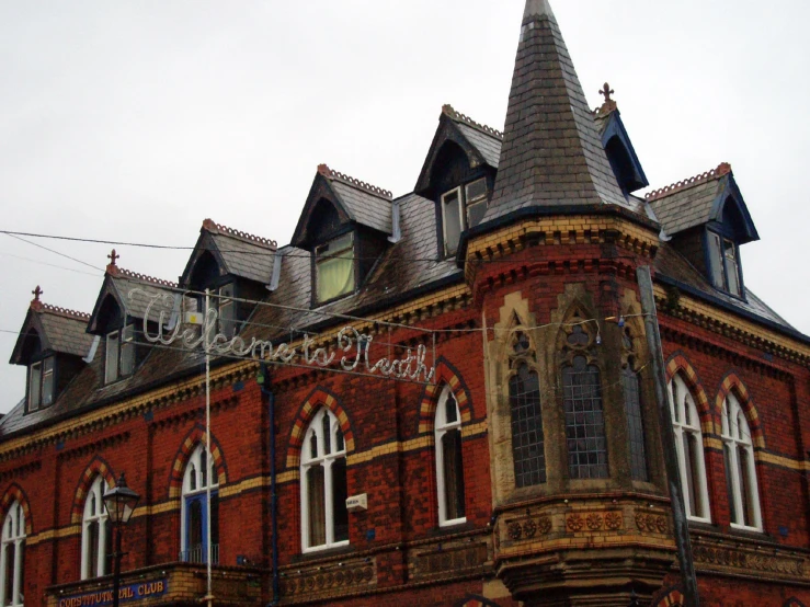 an old brick building with towers and arched windows