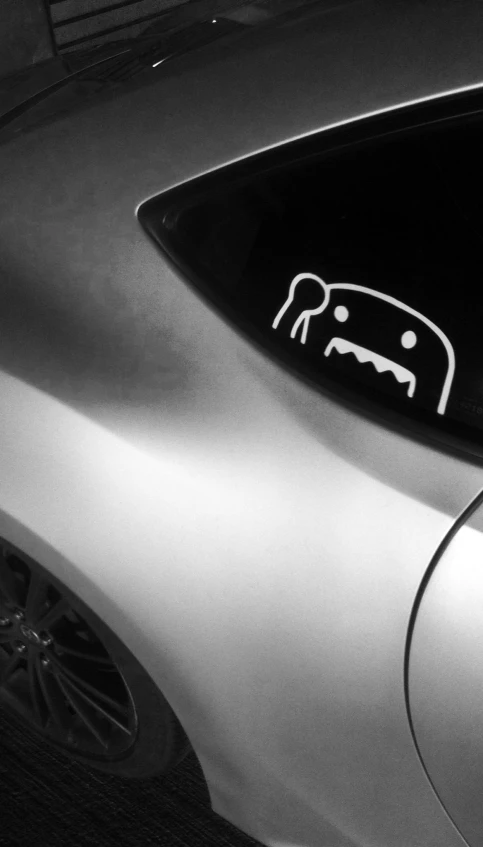 a close up of the tail end of a car with a symbol of a bull and a dog