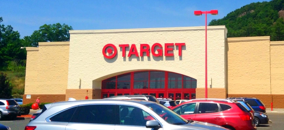 a store is on a busy street that has cars parked in front of it