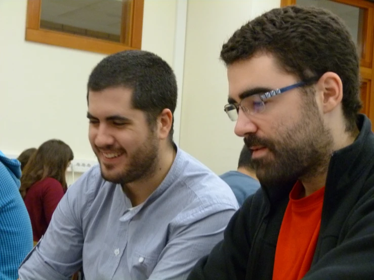 two men sitting down to play a game together