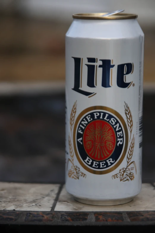 a can of beer sitting on a tiled table