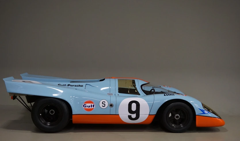 the large blue racing car is on display
