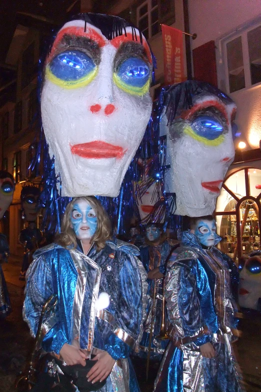 two women in shiny clothing with their faces painted