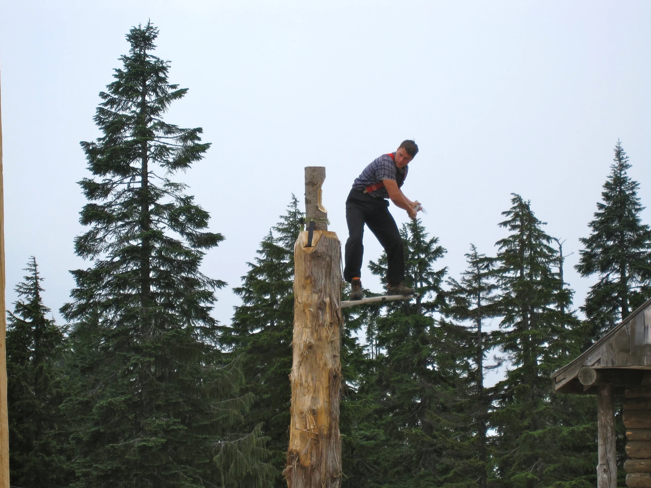 a man skateboarding on top of a wooden post