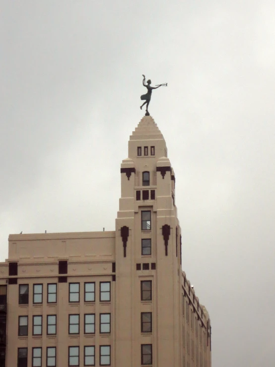 a small bird flying through the air above some buildings