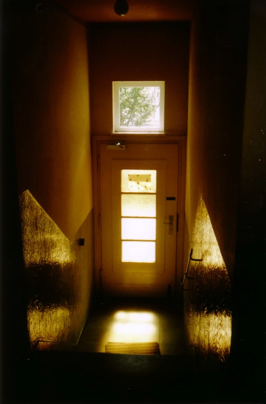 a doorway with light coming through the top window and onto a door