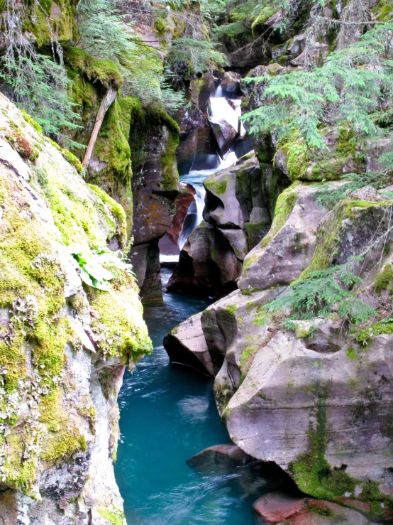 an canyon with a small blue stream in it