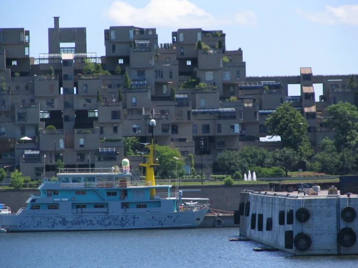 a large blue boat floating next to a bunch of houses