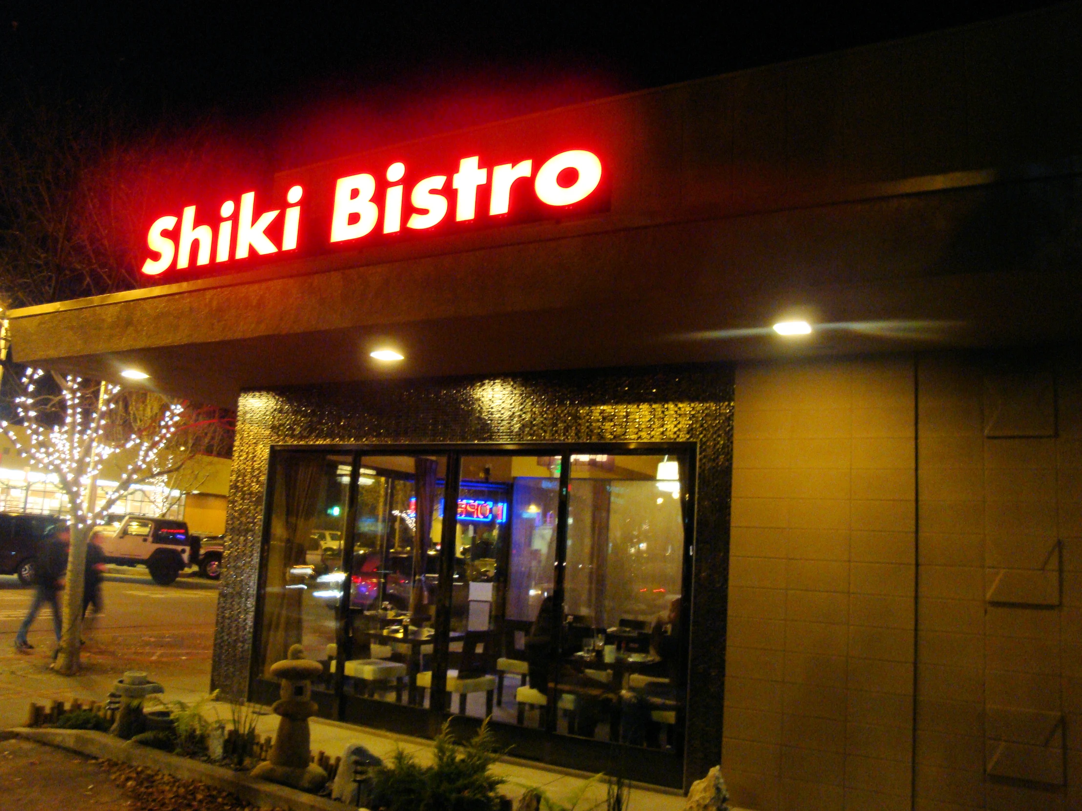 a store front at night lit by street lights